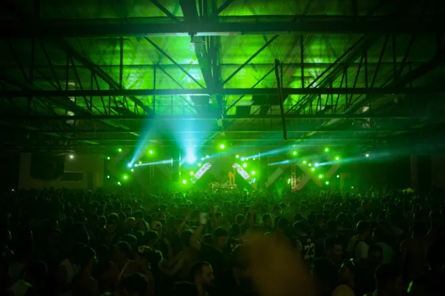 Πίστα σε techno club με πλήθος και φωτισμό